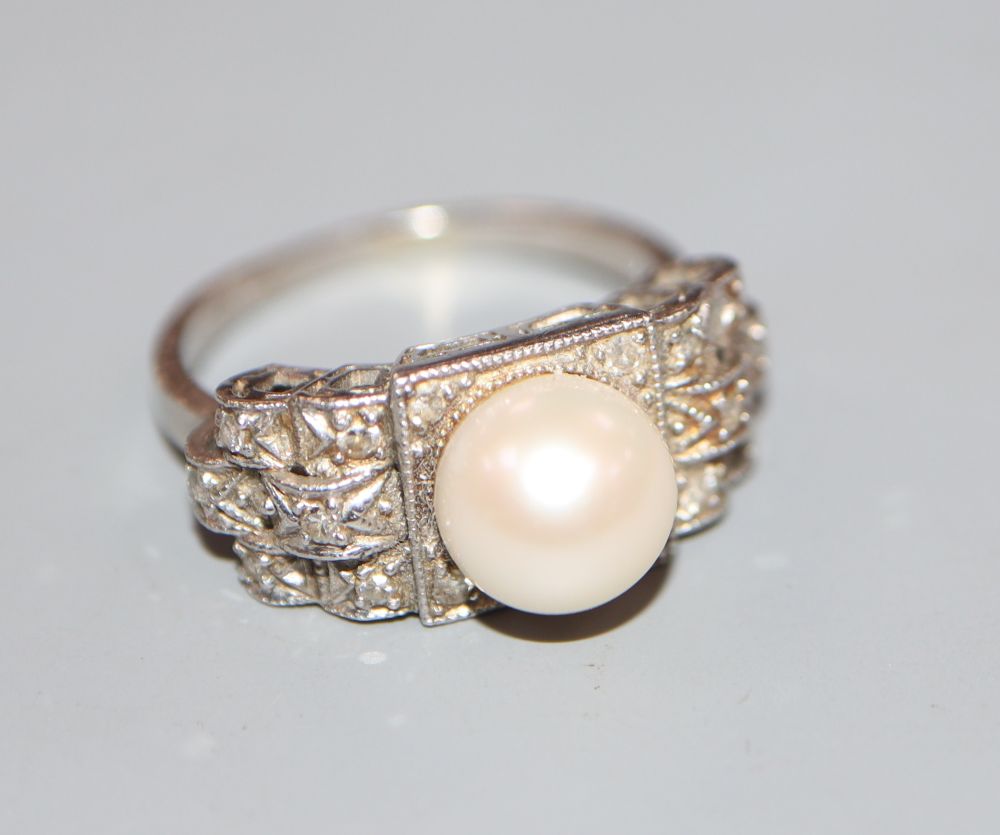 A 1960s? white metal, cultured pearl and diamond chip set dress ring, size K, gross 5.9 grams.
